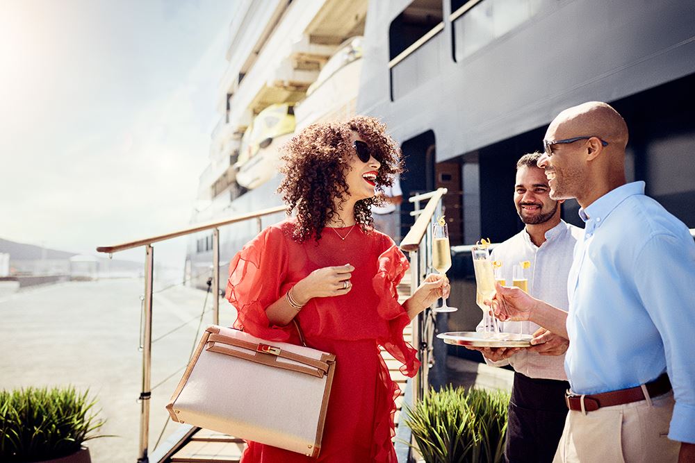 woman boarding yacht with champagne